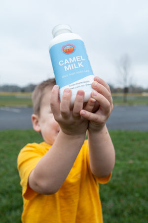 A child drinking a bottle of healthy camel milk.