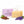 Camel Milk Soap bar set with its lavender-colored packaging box by Camel Culture, styled with almonds, green leaves, and purple lavender sprigs on a white background with a milk splash graphic.
