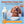 Camel milk product with a dog and text about its qualities on a blue background