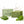 Two rectangular bars of Camel Milk Soap in a natural green shade are displayed in front of their light green packaging box. Fresh green neem and tulsi leaves are arranged around the base of the soap bars, with a stylized white splash graphic in the background.