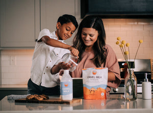 A boy and his mother enjoying the health benefits of camel milk while baking in the kitchen