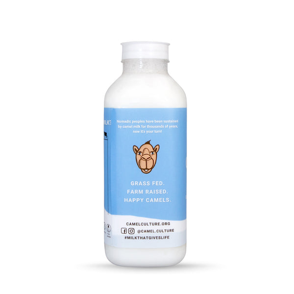A camel milk pint bottle (16 oz.) displaying grass fed, happy camels on the label.